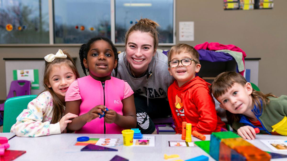 happy children with staff member at pediatric day center