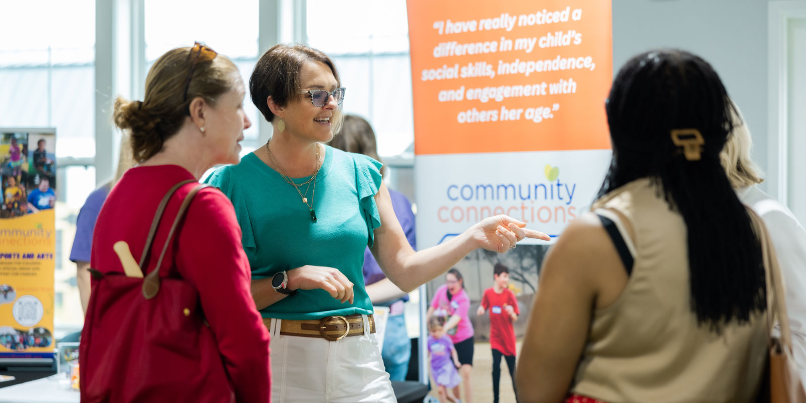 parents and staff conversing at Pediatrics Plus preview event